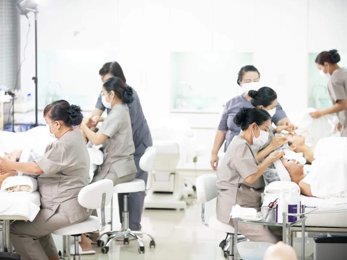 Learners working on clients across the Adele & Smith practice lab during a treatment workshop